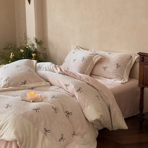 VILZSTUDIOS blush pink fleece bedding set with black embroidered bows and plush cream borders
