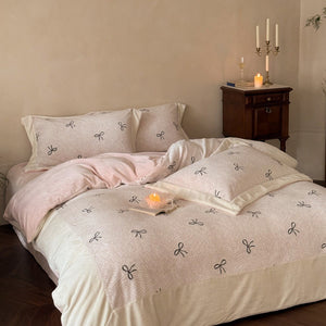 VILZSTUDIOS blush pink fleece bedding set with black embroidered bows and plush cream borders