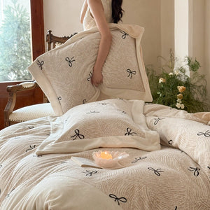 VILZSTUDIOS blush pink fleece bedding set with black embroidered bows and plush cream borders