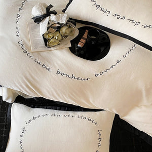 VILZSTUDIOS neutral fleece bedding set with black piping and cursive embroidery