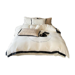 VILZSTUDIOS neutral fleece bedding set with black piping and cursive embroidery