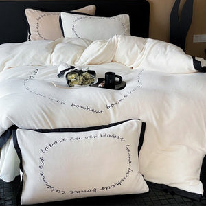 VILZSTUDIOS neutral fleece bedding set with black piping and cursive embroidery