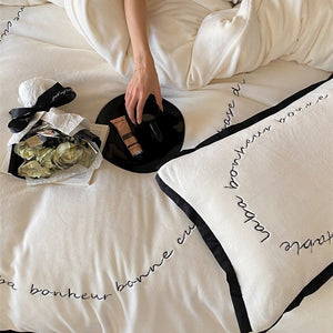 VILZSTUDIOS neutral fleece bedding set with black piping and cursive embroidery