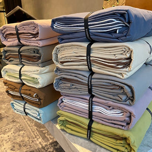 VILZSTUDIOS Neutral and pastel solid-color bedding set with contrast piping on the duvet cover and matching pillowcases