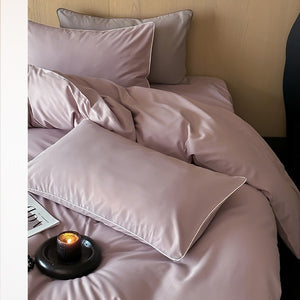 VILZSTUDIOS Neutral and pastel solid-color bedding set with contrast piping on the duvet cover and matching pillowcases