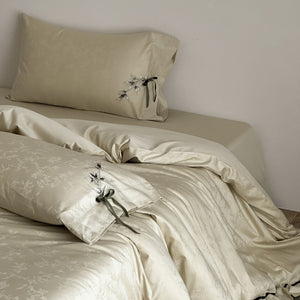 VILZSTUDIOS pale champagne botanical jacquard duvet cover set with embroidered branches and dark green pillowcase bows