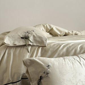 VILZSTUDIOS pale champagne botanical jacquard duvet cover set with embroidered branches and dark green pillowcase bows