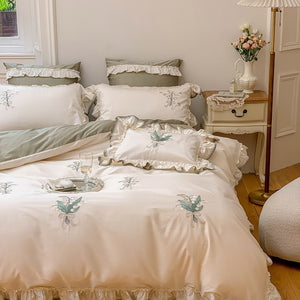 VILZSTUDIOS cream and sage green bedding set with lily-of-the-valley embroidery, lace detailing and layered ruffle trims