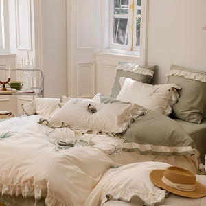 VILZSTUDIOS cream and sage green bedding set with lily-of-the-valley embroidery, lace detailing and layered ruffle trims