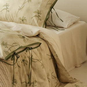 VILZSTUDIOS cream-yellow botanical duvet cover set with olive floral stems and ribbon-tie pillowcases