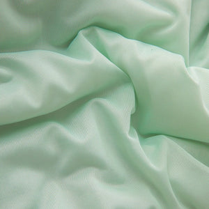 VILZSTUDIOS pastel two-tone summer quilt with circular quilting and piped edges