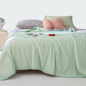 VILZSTUDIOS pastel two-tone summer quilt with circular quilting and piped edges