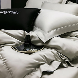 VILZSTUDIOS muted solid-color satin duvet cover set with piped borders and flanged pillowcases