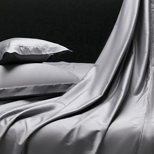 VILZSTUDIOS muted solid-color satin duvet cover set with piped borders and flanged pillowcases