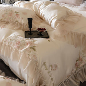 VILZSTUDIOS pale blush pink satin bedding set with rose embroidery and sheer ruffled edges