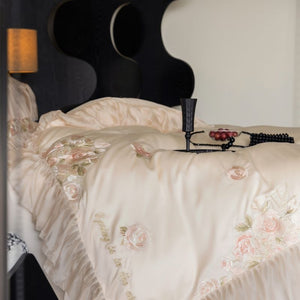 VILZSTUDIOS pale blush pink satin bedding set with rose embroidery and sheer ruffled edges