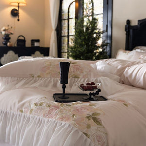 VILZSTUDIOS pale blush pink satin bedding set with rose embroidery and sheer ruffled edges