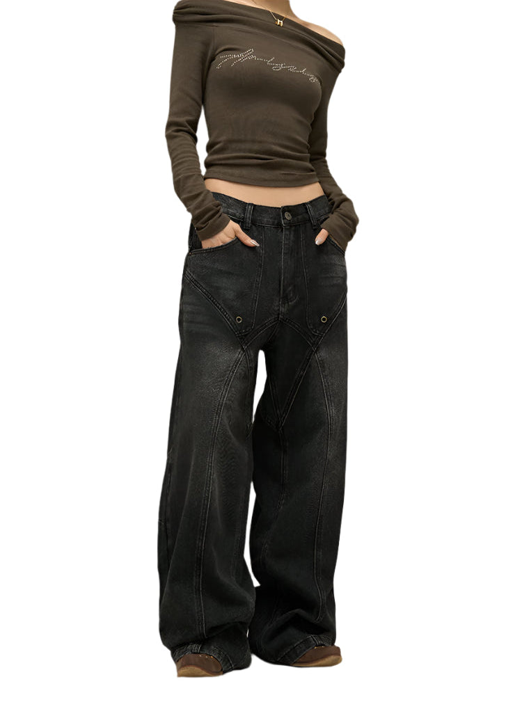Person wearing a brown off-shoulder top and black wide-leg jeans on a neutral background