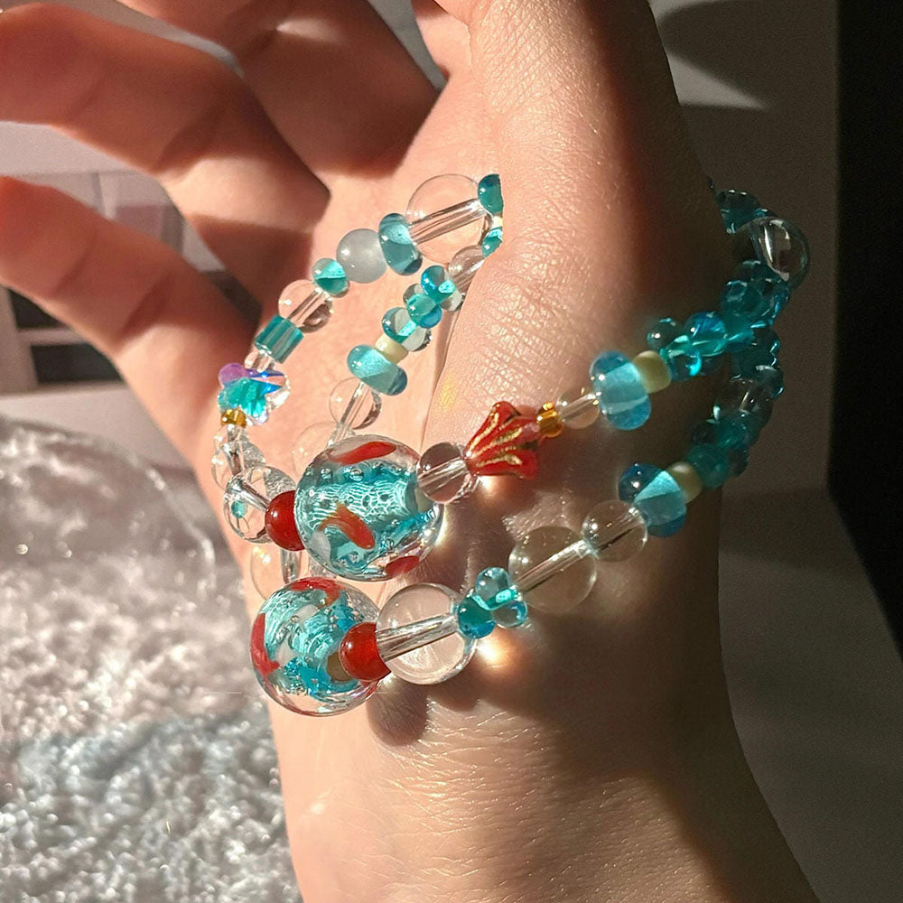VILZSTUDIOS Beaded goldfish bracelet with clear and blue glass beads