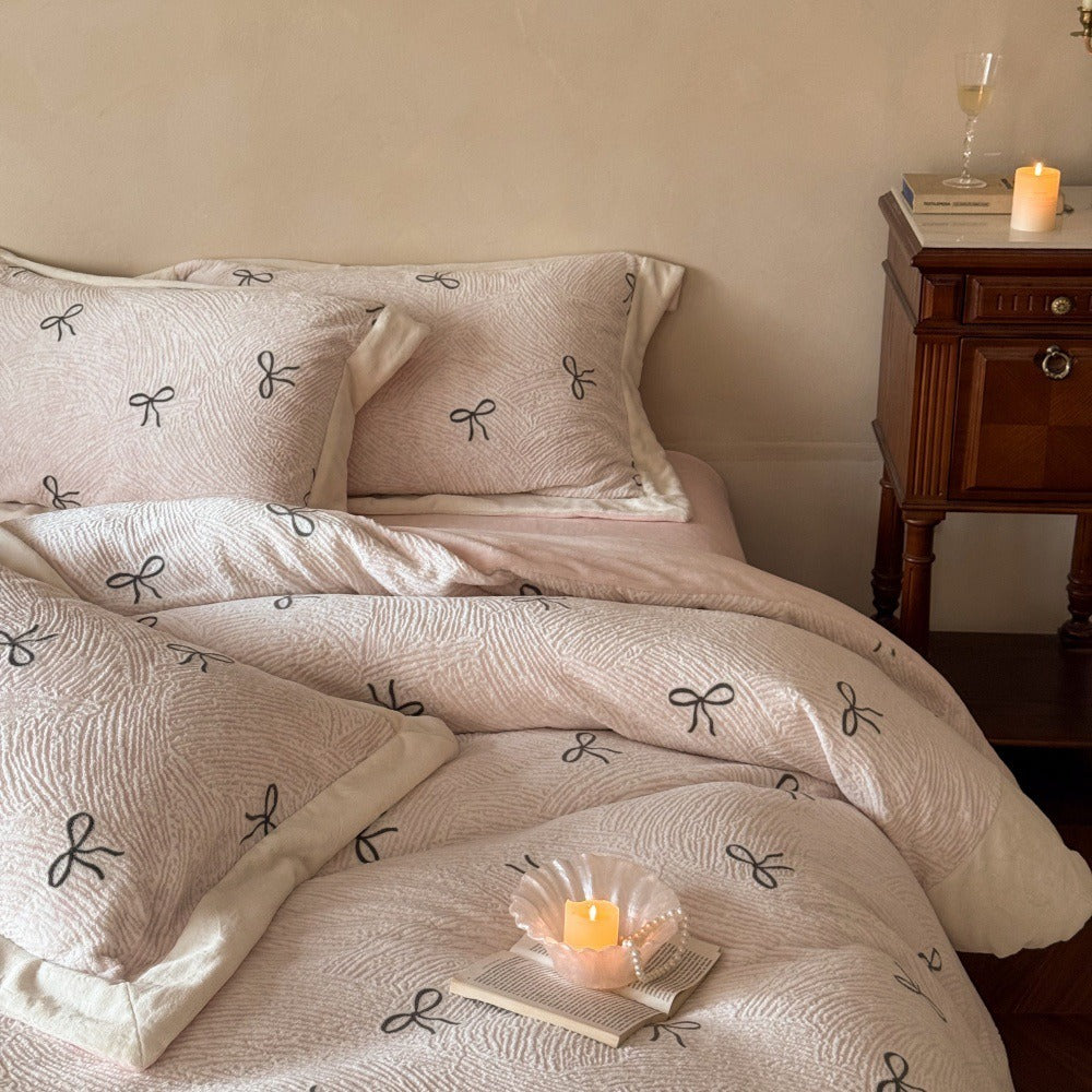 VILZSTUDIOS blush pink fleece bedding set with black embroidered bows and plush cream borders