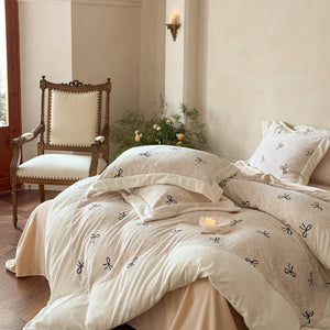 VILZSTUDIOS blush pink fleece bedding set with black embroidered bows and plush cream borders