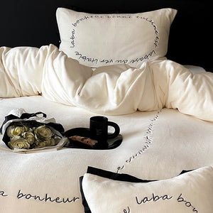 VILZSTUDIOS neutral fleece bedding set with black piping and cursive embroidery