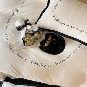 VILZSTUDIOS neutral fleece bedding set with black piping and cursive embroidery