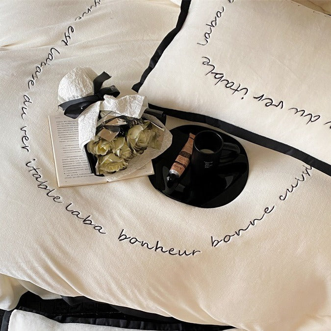 VILZSTUDIOS neutral fleece bedding set with black piping and cursive embroidery