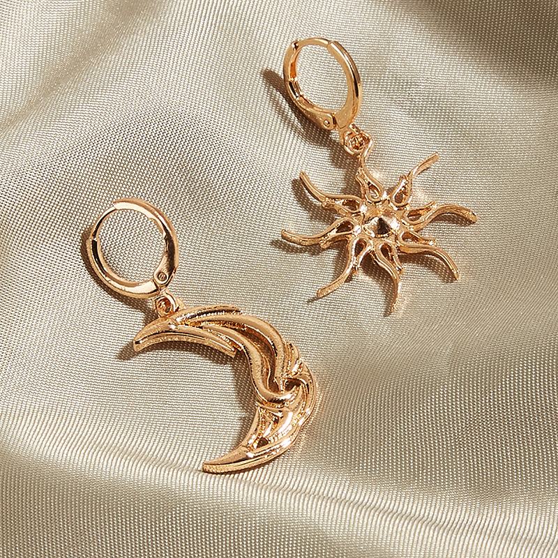 VILZSTUDIOS Mismatched earrings featuring a crescent moon and sun design