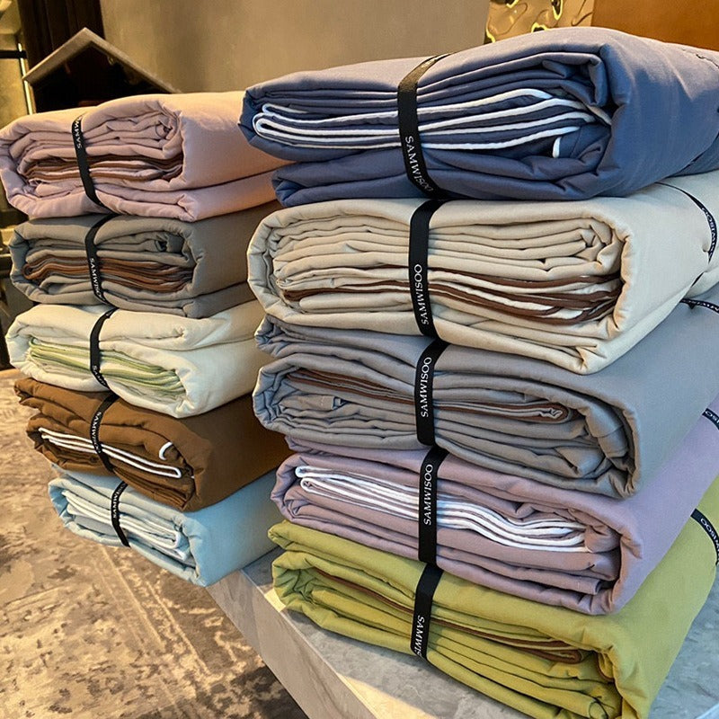 VILZSTUDIOS Neutral and pastel solid-color bedding set with contrast piping on the duvet cover and matching pillowcases