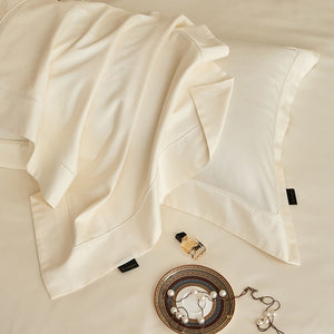 VILZSTUDIOS solid-color satin duvet cover set with matching wide flanged pillowcases and a flat sheet