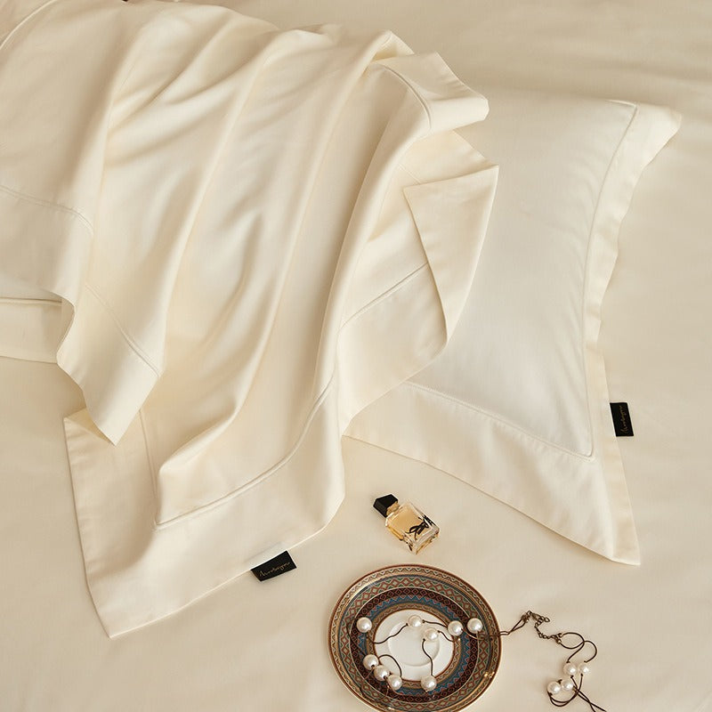 VILZSTUDIOS solid-color satin duvet cover set with matching wide flanged pillowcases and a flat sheet