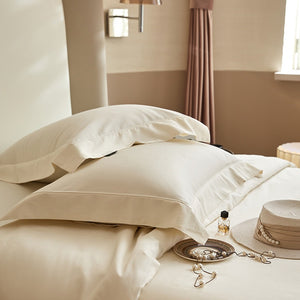 VILZSTUDIOS solid-color satin duvet cover set with matching wide flanged pillowcases and a flat sheet