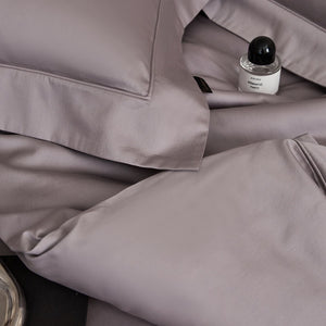 VILZSTUDIOS solid-color satin duvet cover set with matching wide flanged pillowcases and a flat sheet