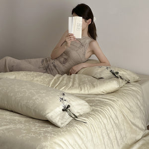 VILZSTUDIOS pale champagne botanical jacquard duvet cover set with embroidered branches and dark green pillowcase bows