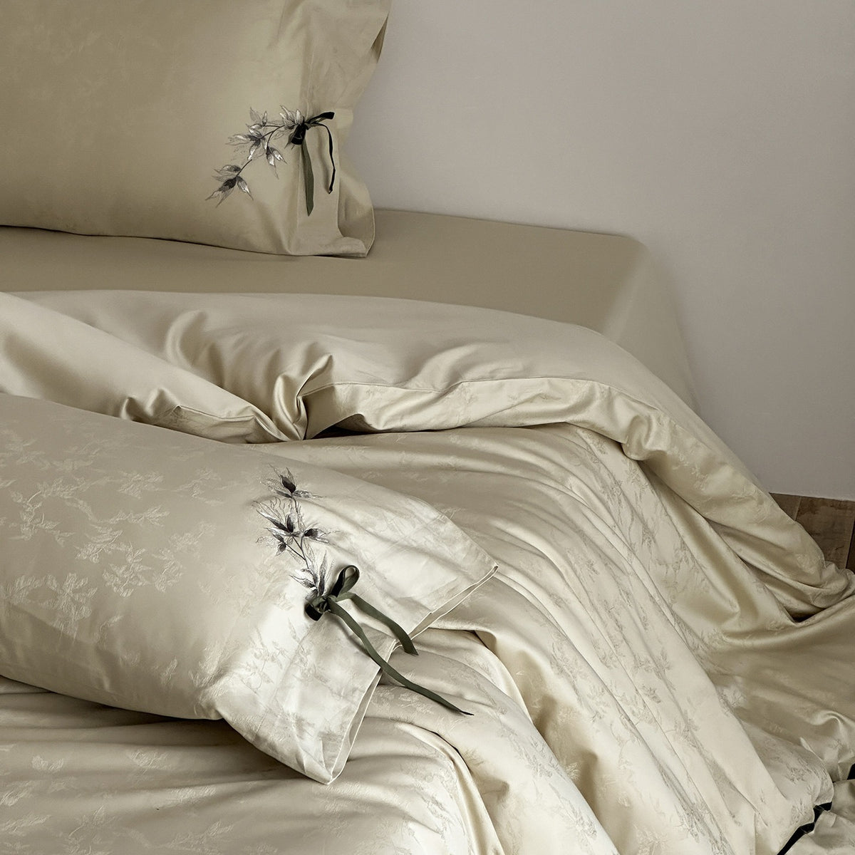 VILZSTUDIOS pale champagne botanical jacquard duvet cover set with embroidered branches and dark green pillowcase bows