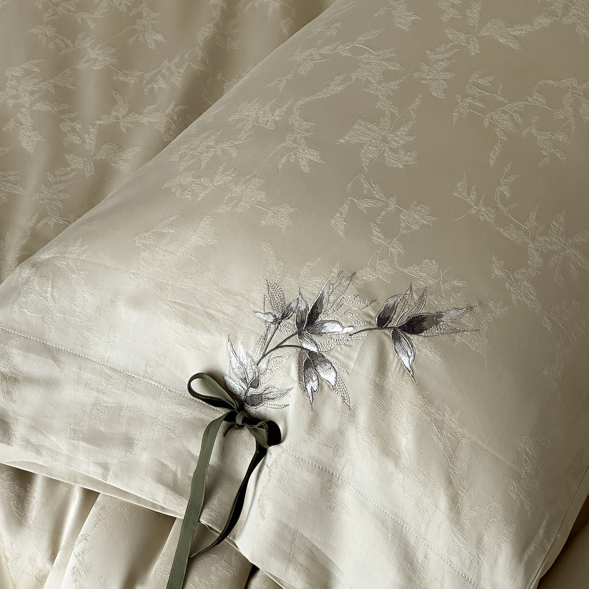 VILZSTUDIOS pale champagne botanical jacquard duvet cover set with embroidered branches and dark green pillowcase bows