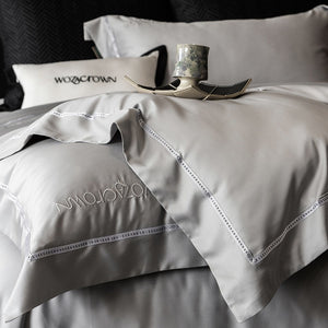 VILZSTUDIOS solid-color satin duvet cover set with wide flanged borders and delicate hemstitch trim