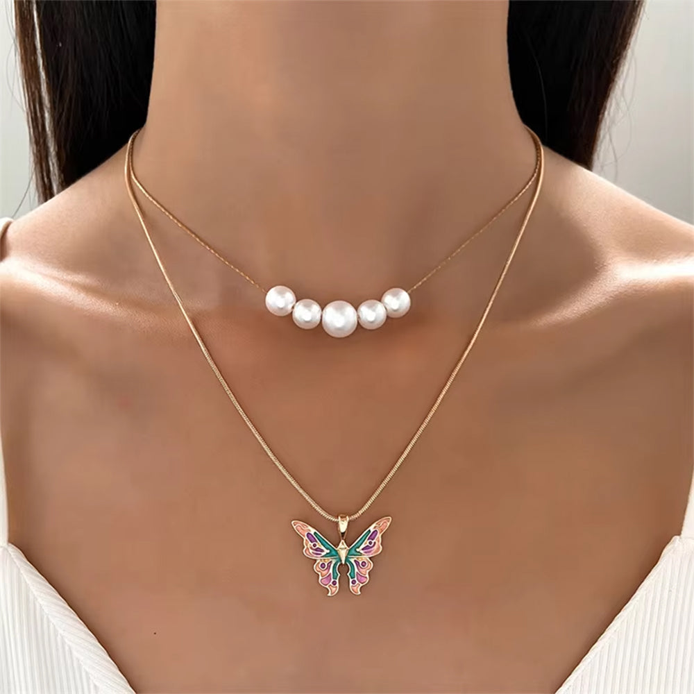 VILZSTUDIOS Layered necklace featuring butterfly charm and pearl accents