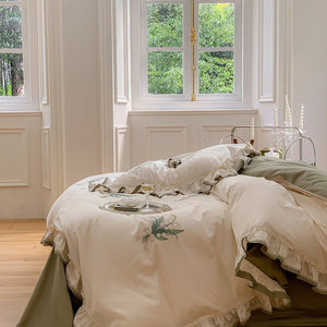 VILZSTUDIOS cream and sage green bedding set with lily-of-the-valley embroidery, lace detailing and layered ruffle trims