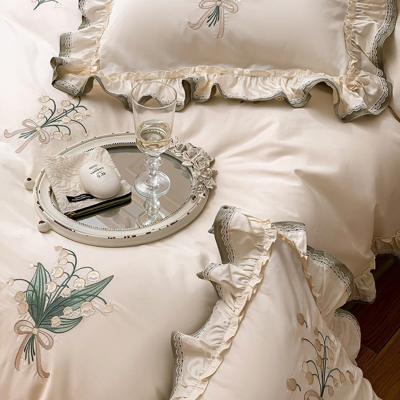 VILZSTUDIOS cream and sage green bedding set with lily-of-the-valley embroidery, lace detailing and layered ruffle trims