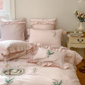 VILZSTUDIOS cream and sage green bedding set with lily-of-the-valley embroidery, lace detailing and layered ruffle trims