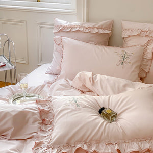 VILZSTUDIOS cream and sage green bedding set with lily-of-the-valley embroidery, lace detailing and layered ruffle trims