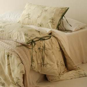 VILZSTUDIOS cream-yellow botanical duvet cover set with olive floral stems and ribbon-tie pillowcases