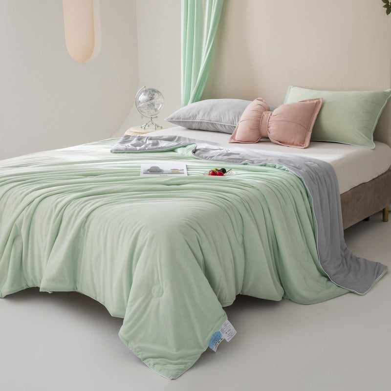VILZSTUDIOS pastel two-tone summer quilt with circular quilting and piped edges