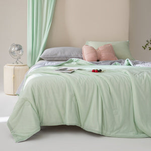VILZSTUDIOS pastel two-tone summer quilt with circular quilting and piped edges