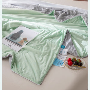 VILZSTUDIOS pastel two-tone summer quilt with circular quilting and piped edges