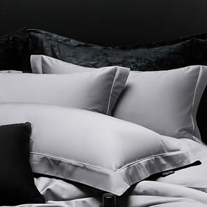 VILZSTUDIOS muted solid-color satin duvet cover set with piped borders and flanged pillowcases