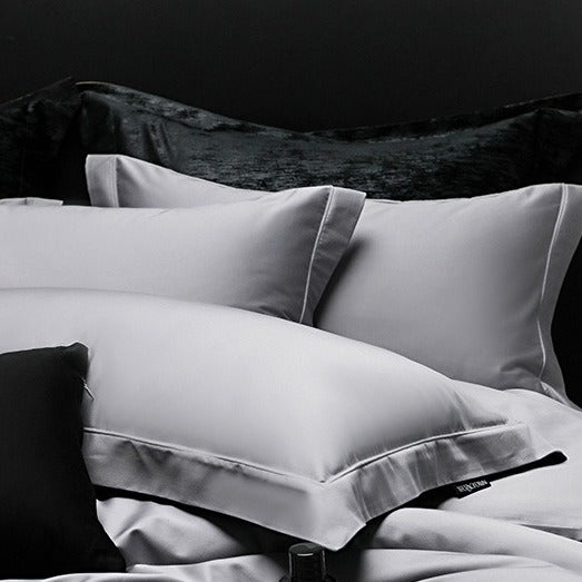 VILZSTUDIOS muted solid-color satin duvet cover set with piped borders and flanged pillowcases