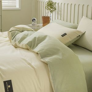 VILZSTUDIOS pastel and warm neutral reversible bedding set with small rectangular woven accent patches